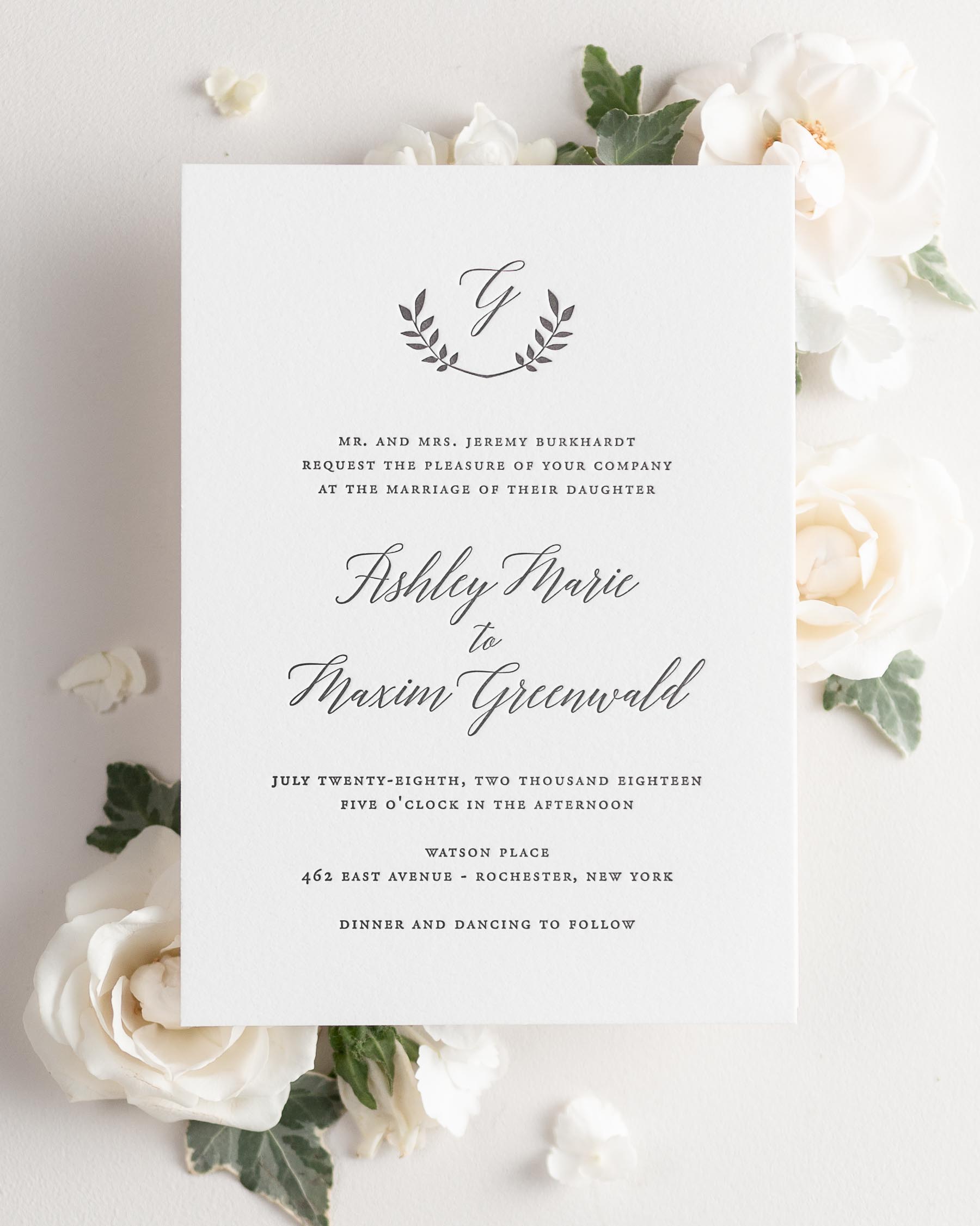 Wreath Monogram letterpress wedding invitation styled with pretty florals.
