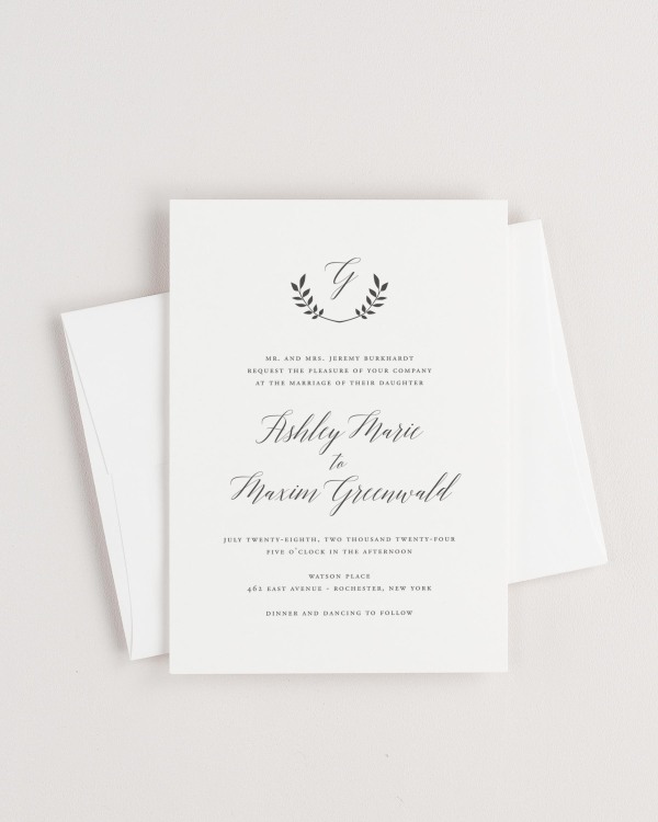 Simple close-up of Wreath Monogram invitation with an envelope.