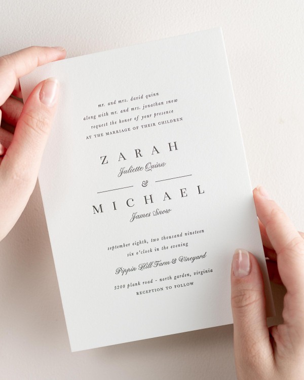 Bride holding her 5x7” Zarah letterpress wedding invitation.