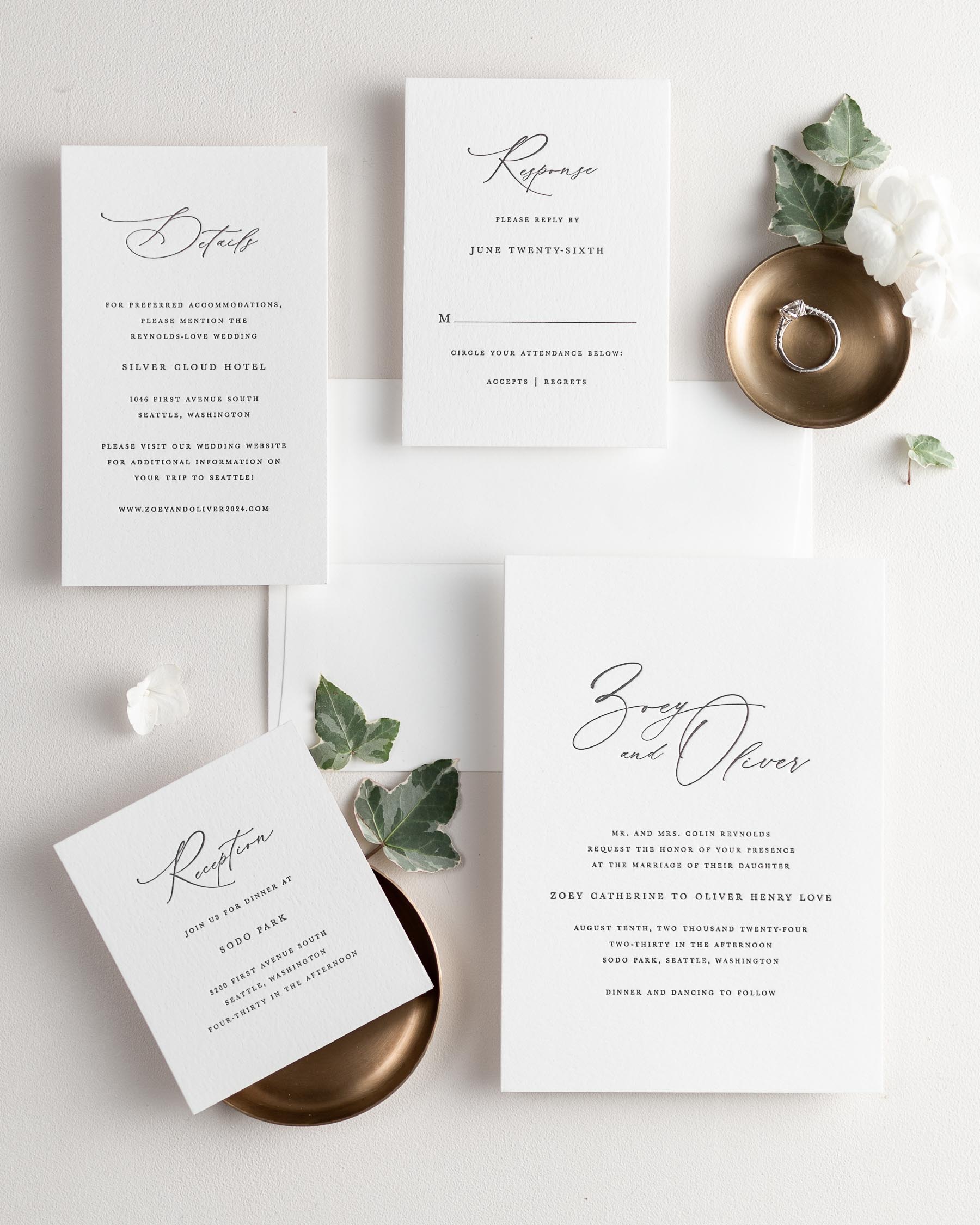 All pieces of the Zoey letterpress wedding invitation suite, including the invitation, small and large enclosures, and response card.