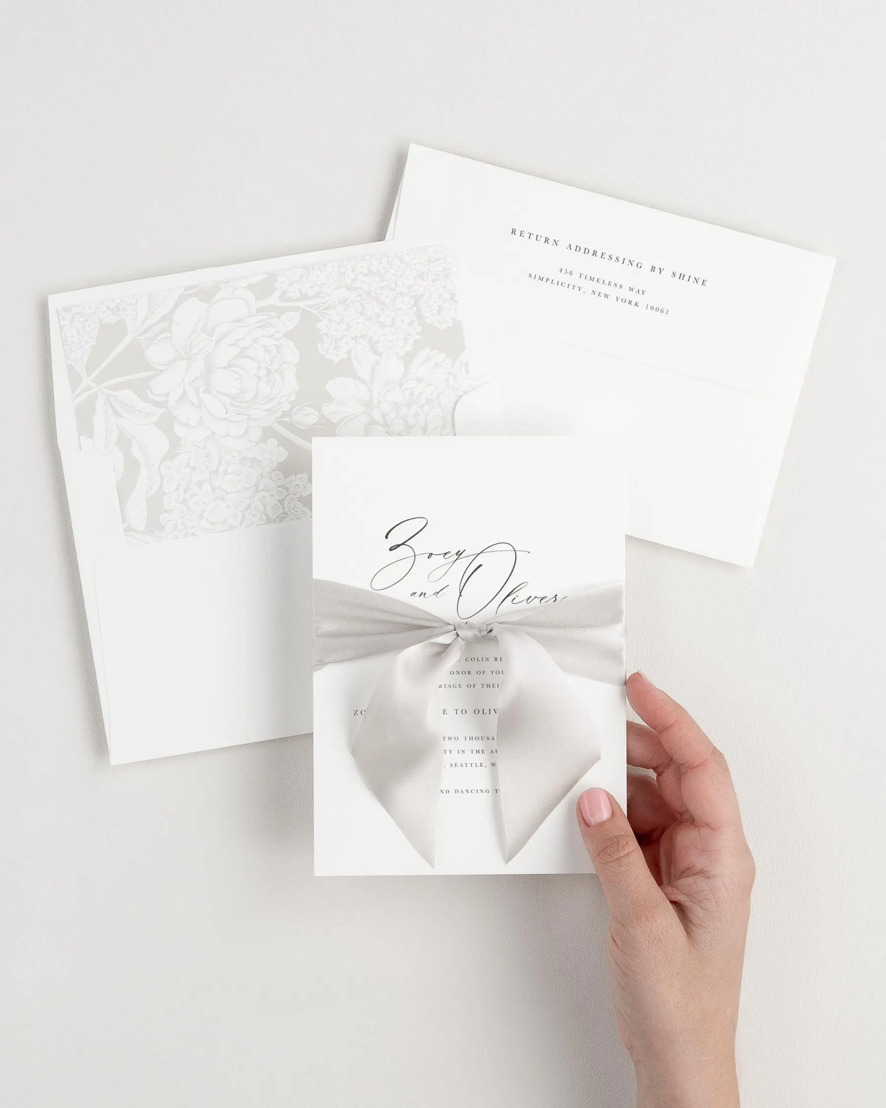 Warm Gray Ribbon Tied Around a Zoey Wedding Invitation